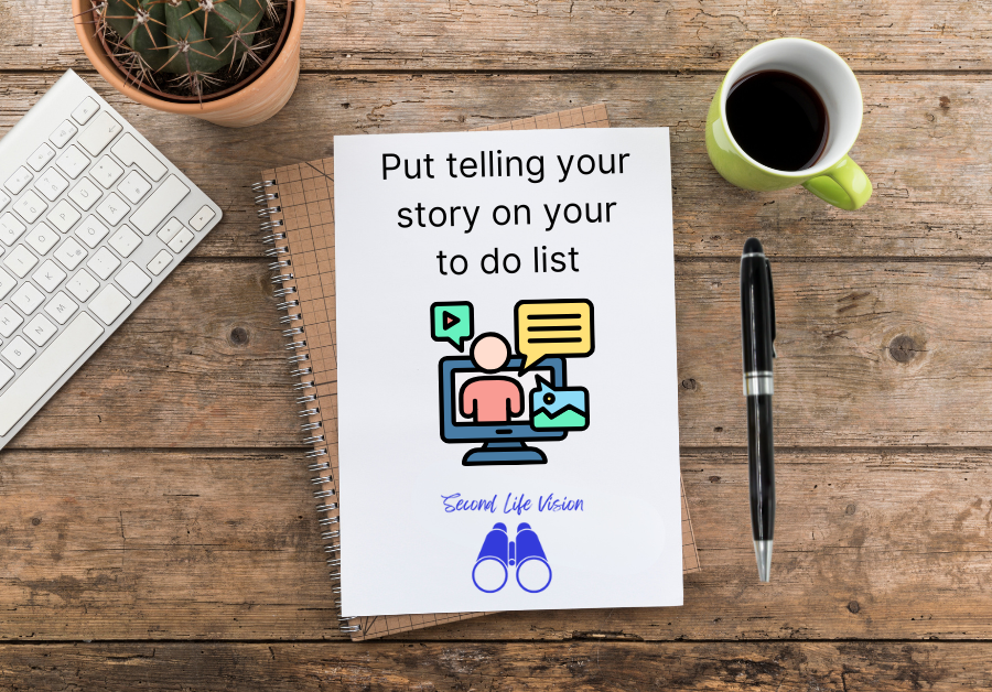 Notebook with "Put telling your story on your to do list" written on the page, on a desktop beside a computer keyboard, a pen and a cup of coffee.